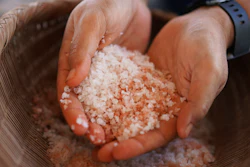 Malia Nobrega-Olivera holds Hawaiian salt, or 'paakai,' Hanapepe, Hawaii, July 10, 2023.