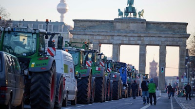 Tractors in front of the Brandenburg Gate during a farmers' protest, Berlin, Jan. 8, 2024.