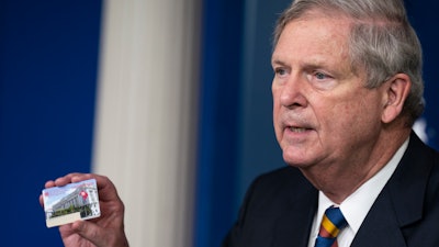 Agriculture Secretary Tom Vilsack holds up a SNAP EBT card during a news conference at the White House, May 5, 2021.
