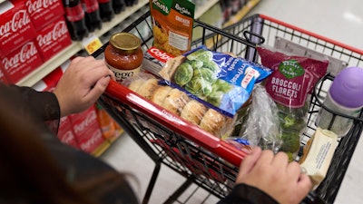 A shopper pushes a cart of groceries at a supermarket in Bellflower, Calif., Feb. 13, 2023.