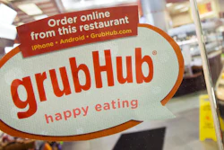 A sign with the old GrubHub logo displayed on the door to a New York restaurant, April 4, 2014.