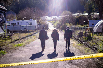 FBI officials walk towards the crime scene at Mountain Mushroom Farm, Half Moon Bay, Calif., Jan. 24, 2023.