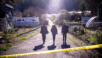 FBI officials walk towards the crime scene at Mountain Mushroom Farm, Half Moon Bay, Calif., Jan. 24, 2023.