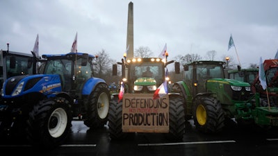 Farmers block a roundabout in Fontainebleau, France, Jan. 26, 2024.