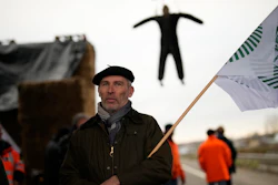 A farmer stands at a barricade in Jossigny, France, Jan. 30, 2024.