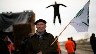 A farmer stands at a barricade in Jossigny, France, Jan. 30, 2024.