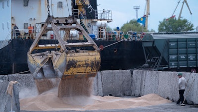Workers load grain at a port in Izmail, Ukraine, April 26, 2023.