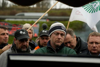 Farmers watch French Prime Minister Gabriel Attal announcing new measures for farmers, Chilly-Mazarin, France, Feb.1, 2024.