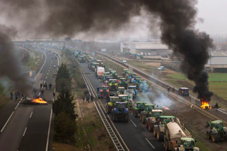 Farmers make barricades after blocking a highway near Mollerussa, Spain, Feb. 6, 2024.