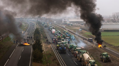 Farmers make barricades after blocking a highway near Mollerussa, Spain, Feb. 6, 2024.