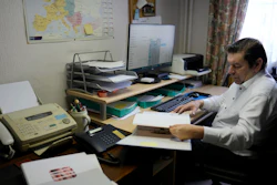 Bart Dochy looks through accounting books at his family farm in Ledegem, Belgium, Feb. 13, 2024.