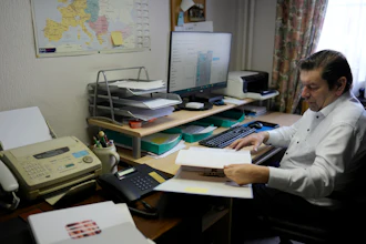 Bart Dochy looks through accounting books at his family farm in Ledegem, Belgium, Feb. 13, 2024.