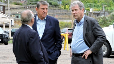 U.S. Sens. Joe Manchin, D-W.Va., center, and Sherrod Brown, D-Ohio, right, speak with Cleveland-Cliffs CEO Lourenco Goncalves, Weirton, W.Va., Sept. 26, 2023.