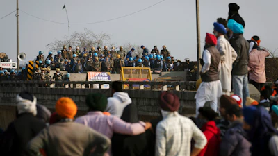 Protesting farmers face a police barricade near Shambhu, India, Feb.16, 2024.