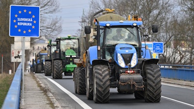 Czech farmers in tractors make their way to the Hodonín/Holíč, Czech-Slovakia border crossing, Feb. 22, 2024.