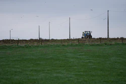 A farmer riding a tractor works in a field in West Flanders, Belgium, Feb. 21, 2024.
