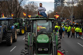 A farmer sits atop a tractor during a protest outside the European Parliament offices in Madrid, Feb. 26, 2024.