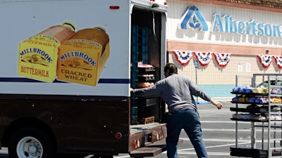 Mitch Maddox loads bread outside the Eagle Rock Albertsons store in Los Angeles, May 30, 2006.