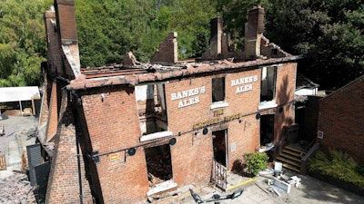 The burnt out remains of The Crooked House pub near Dudley, England, July 8, 2023.