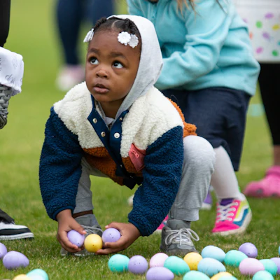 A youngster collects Easter eggs during an egg hunt at the Bowling Green Ballpark, Bowling Green, Ky., April 8, 2023.