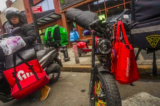 A food delivery worker prepares to ride off from a fast-food restaurant on Brooklyn's Flatbush Avenue, Jan. 29, 2024.