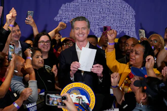 California Gov. Gavin Newsom surrounded by fast food workers at SEIU Local 721, Los Angeles, Sept. 28, 2023.
