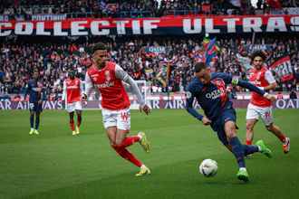 PSG's Kylian Mbappe, right, and Reims' Amir Richardson fight for the ball during a match between Paris Saint-Germain and Reims at the Parc des Princes stadium, Paris, France, March 10, 2024.