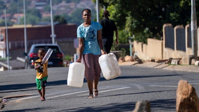 Residents line up for water, Soweto, South Africa, March 16, 2024.
