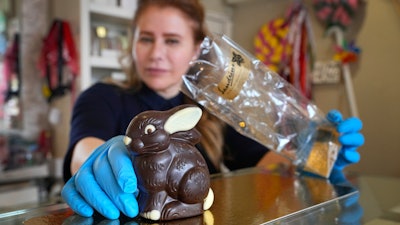 Niaz Mardan wraps a Belgian chocolate rabbit at Sandrine, London, March 21, 2024.