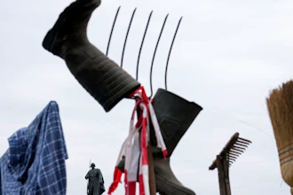 A farmer's shirt, boots, pitchfork and broom displayed during protest in Berlin, March 22, 2024.
