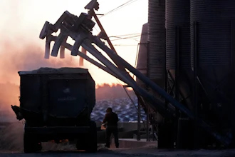 A feed truck is loaded at the Flood Brothers Farm, Clinton, Maine, April 1, 2024.