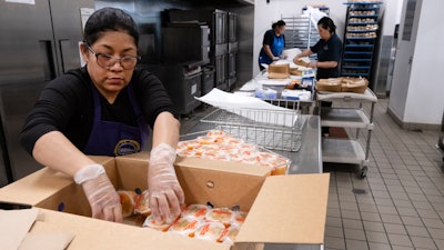 Firebaugh High School cafeteria worker Claudia Rodriguez prepares fruit cups, Lynwood, Calif., April 3, 2024.
