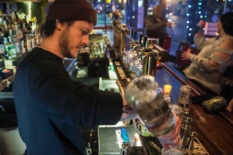 Rob Waltar, managing partner of the Fulton Grand bar in New York, make drinks for customers, Feb. 28, 2024.