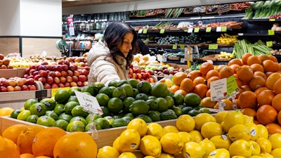A woman browses produce at a grocery store in New York, Jan. 19, 2024.