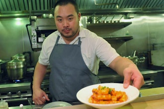 David Chang presents a dish at Momofuku Noodle Bar in New York, Nov. 10, 2011.