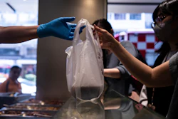 A customer collects a takeaway food plastic bag at Kuen Fat Kitchen in Hong Kong, April 10, 2024.