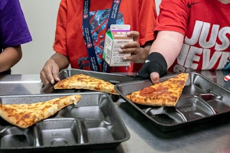 Second-grade students select meals in the cafeteria of an elementary school in Scottsdale, Ariz., Dec. 12, 2022.