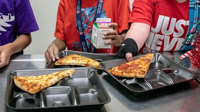 Second-grade students select meals in the cafeteria of an elementary school in Scottsdale, Ariz., Dec. 12, 2022.