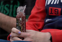 A Minnesota Twins fan holds a sausage before a baseball game against the Chicago White Sox in Chicago, April 29, 2024.