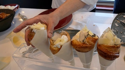 Twisted croissants with artichoke puree, a poached egg, a bit of truffle and a bit of cheese, created by French chef Amandine Chaignot, shown in Paris, April 30, 2024.