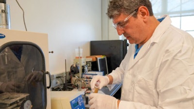 Auburn University Research Professor Burak Aksoy working on gas sensor components.