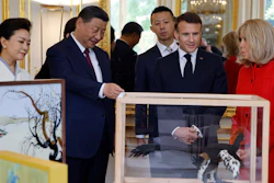 China's President Xi Jinping, second left, presents gifts to French President Emmanuel Macron at the Elysee Palace, Paris, May 6, 2024.
