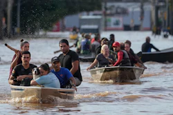 Volunteers help evacuate residents from an area flooded by heavy rains, Porto Alegre, Brazil, May 7, 2024.