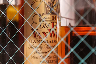 A bottle of 10-year-old Old Pappy Van Winkle bourbon behind glass doors at a bar, March 4, 2023.