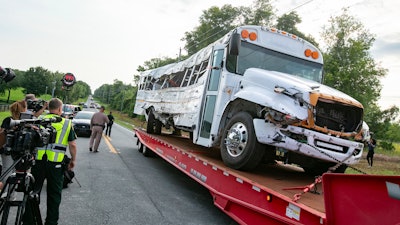 A bus is removed after it collied with a pickup in Ocala, Fla., May 14, 2024.