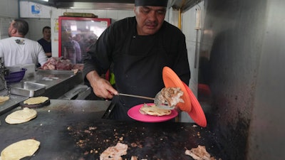 Chef Arturo Rivera Martínez at the Tacos El Califa de León taco stand, Mexico City, May 15, 2024.