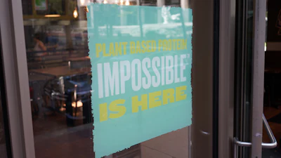 A QDOBA Mexican Eats restaurant in downtown Portland advertises the availability of Impossible brand plant-based protein in 2019.