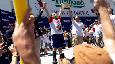 Joey Chestnut celebrates winning the Nathan's Famous Fourth of July hot dog eating contest in Coney Island in 2022.