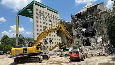 Workers knock down the former Coca-Cola Co. museum in downtown Atlanta.