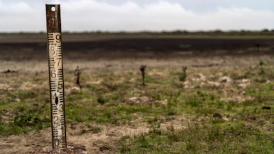 A water meter stands in a dry wetland in Donana natural park, southwest Spain.